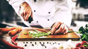 a chef is cutting vegetable